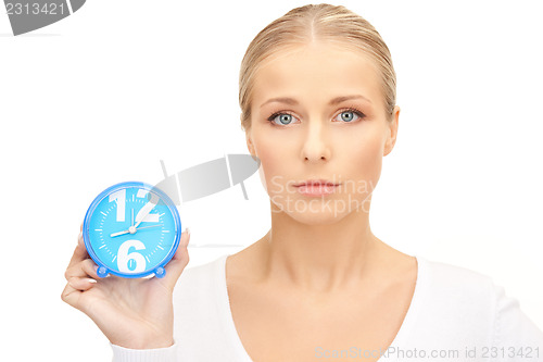 Image of woman holding alarm clock