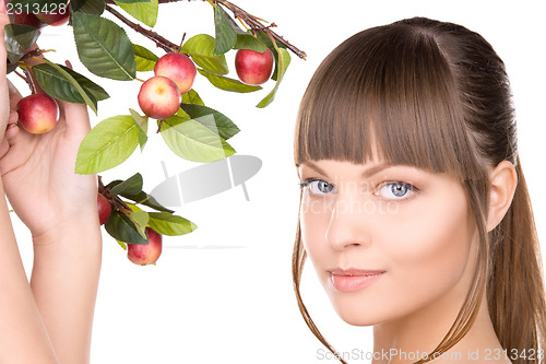 Image of lovely woman with apple twig