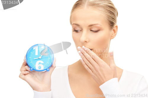 Image of woman holding alarm clock