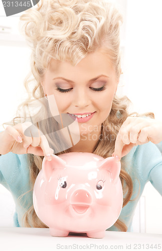 Image of lovely woman with piggy bank