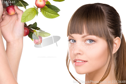 Image of lovely woman with apple twig