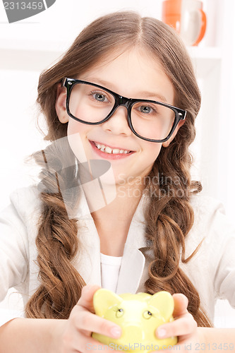 Image of little girl with piggy bank