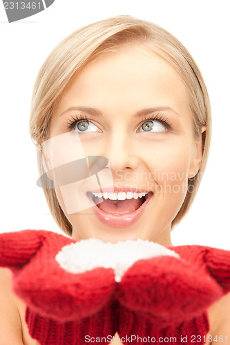 Image of beautiful woman in red mittens with snow