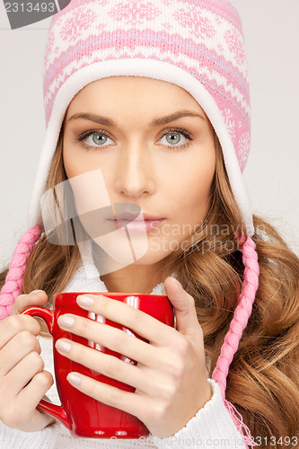 Image of beautiful woman with red mug