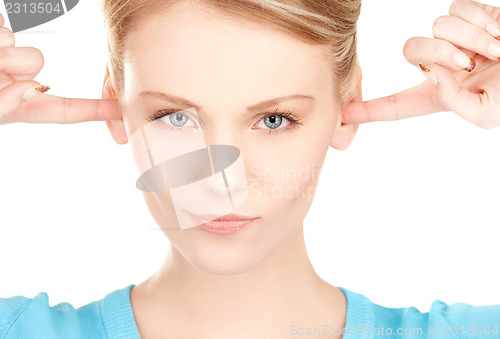 Image of woman with fingers in ears