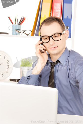 Image of businessman with laptop computer in office