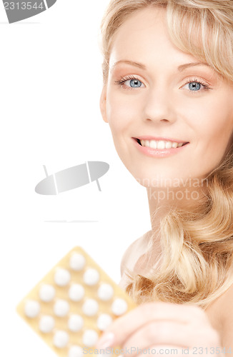 Image of young woman with pills