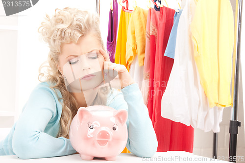 Image of lovely woman with piggy bank