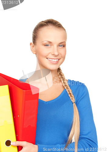 Image of young attractive businesswoman with folders