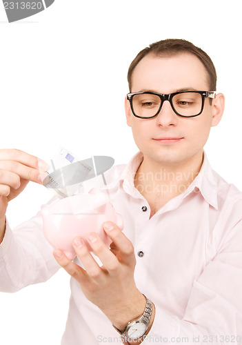 Image of businessman with piggy bank and money