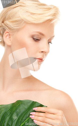 Image of woman with green leaf