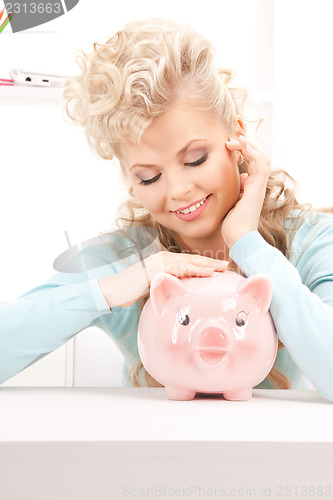Image of lovely woman with piggy bank