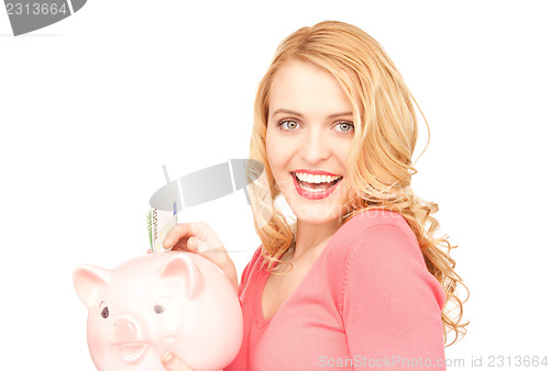 Image of lovely woman with piggy bank and money