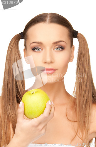 Image of young beautiful woman with green apple