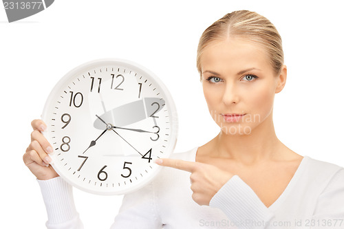 Image of woman holding big clock