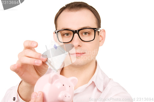 Image of businessman with piggy bank and money