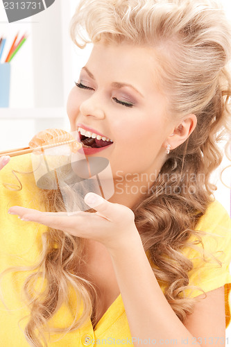 Image of lovely woman eating sushi