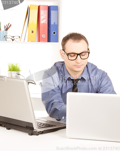 Image of businessman with laptop computer in office