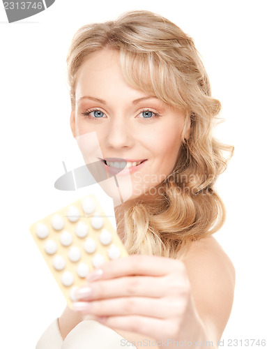 Image of young woman with pills