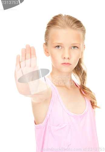 Image of lovely girl showing stop sign