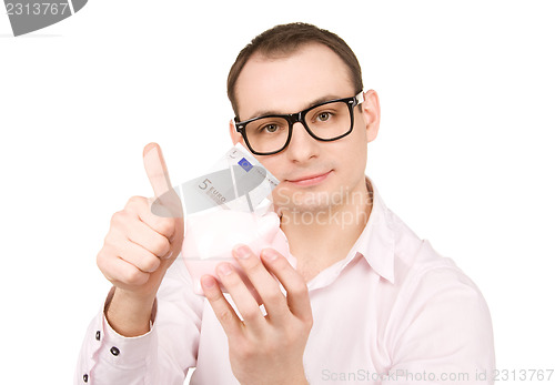 Image of businessman with piggy bank and money