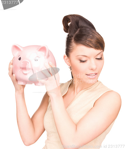 Image of lovely woman with piggy bank