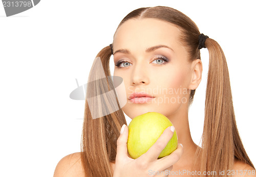 Image of young beautiful woman with green apple