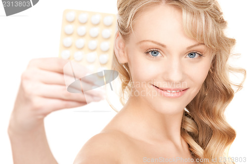 Image of young woman with pills