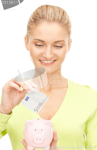 Image of woman with piggy bank and money