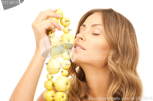Image of lovely woman with green apples