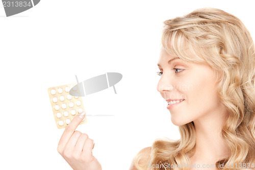 Image of young woman with pills