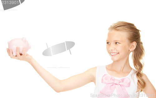 Image of lovely teenage girl with piggy bank