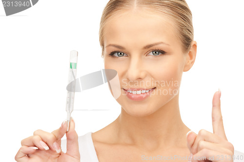 Image of attractive female doctor with thermometer