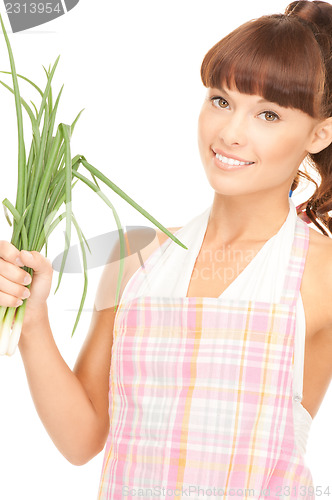 Image of beautiful housewife with spring onions over white