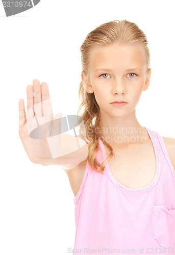 Image of lovely girl showing stop sign