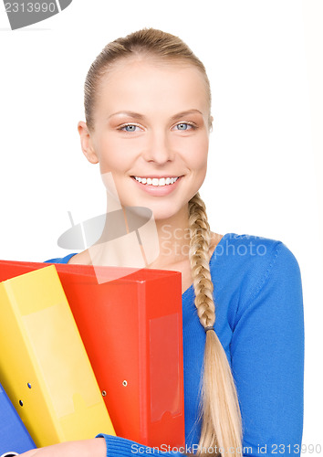 Image of young attractive businesswoman with folders