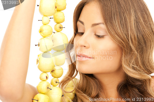 Image of lovely woman with green apples