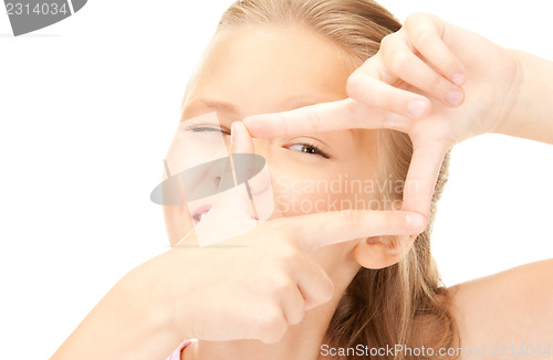 Image of pretty girl creating a frame with fingers
