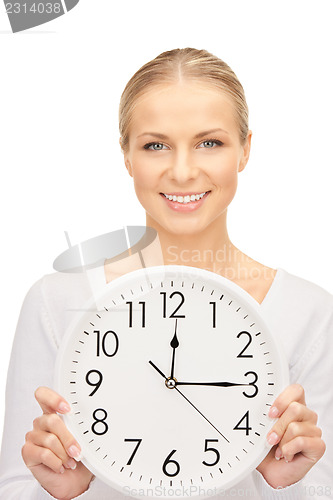 Image of woman holding big clock