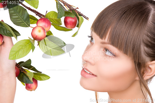 Image of lovely woman with apple twig