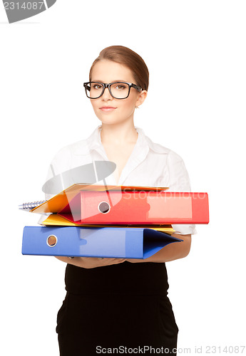 Image of young attractive businesswoman with folders 