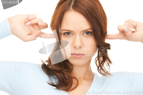 Image of woman with fingers in ears