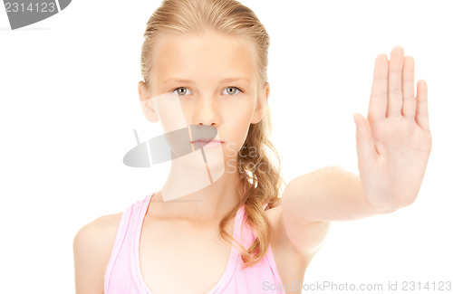 Image of lovely girl showing stop sign