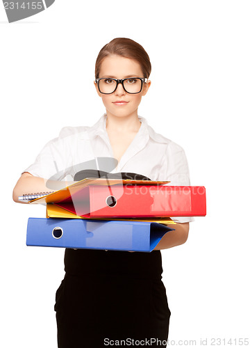 Image of young attractive businesswoman with folders 