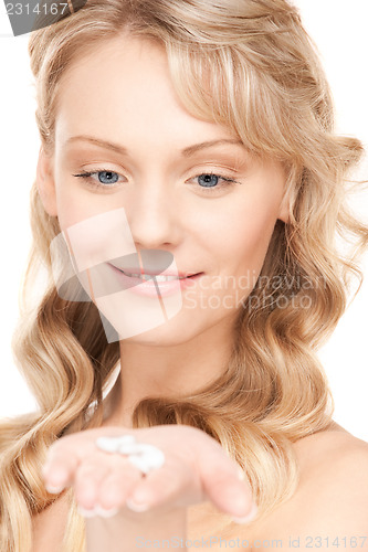 Image of young woman with pills