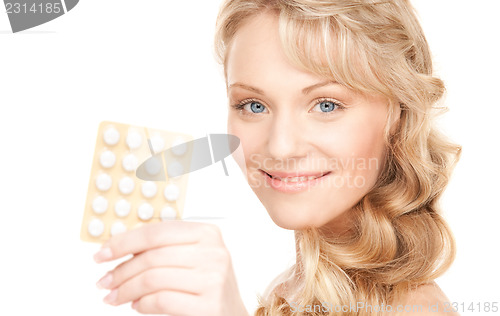 Image of young woman with pills