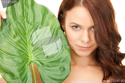 Image of woman with green leaf