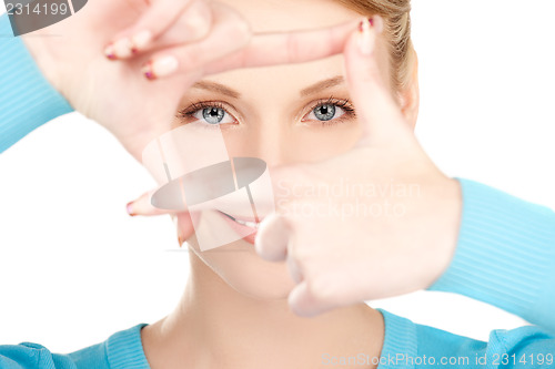 Image of lovely woman creating a frame with fingers