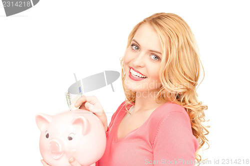 Image of lovely woman with piggy bank and money