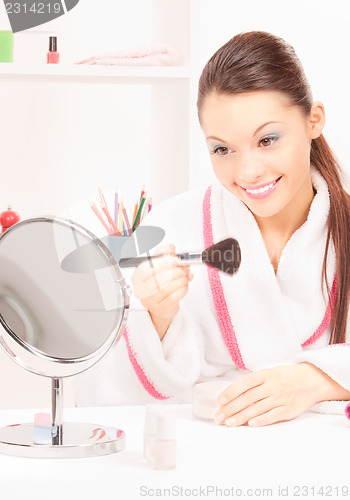 Image of lovely woman with brush and mirror